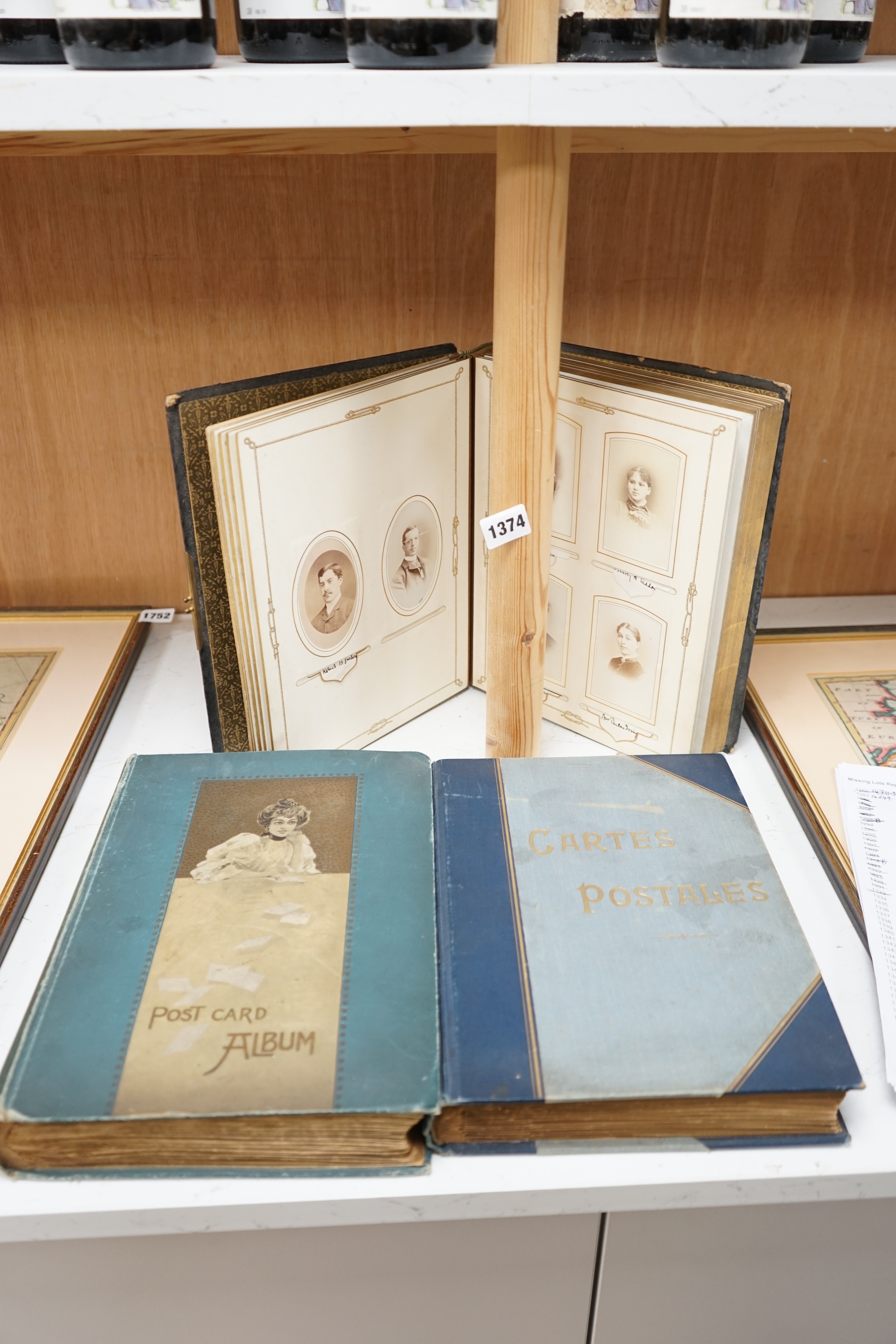 An Edwardian Royal commemorative photograph ‘nautical album’, mostly Royal Navy, leather bound, together with two early 20th century topographical, world and British postcard albums. Condition - good